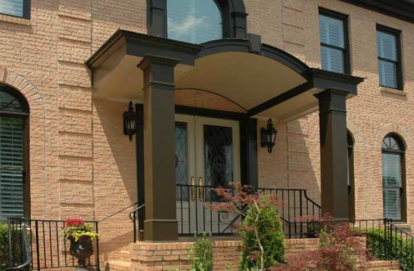 AFTER installation of arched roof portico with light brick home long windows