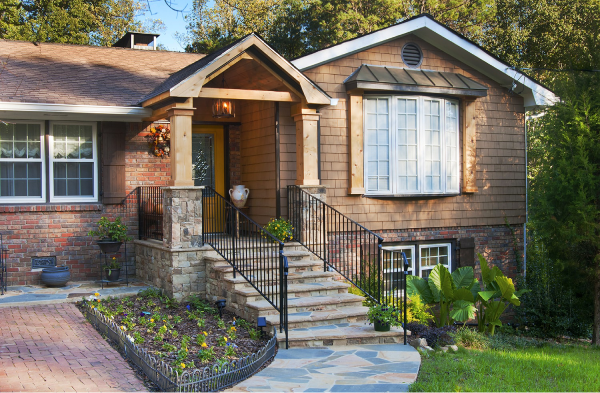 AFTER portico installation on house with wooden shutters and stone steps with metal railing 2