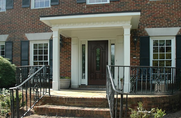 brick home black shutters AFTER white shed roof portico installation