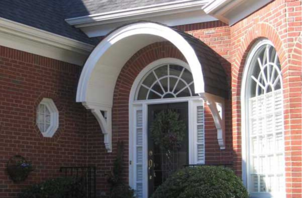 AFTER installation of round bracket portico with wreath on brick home