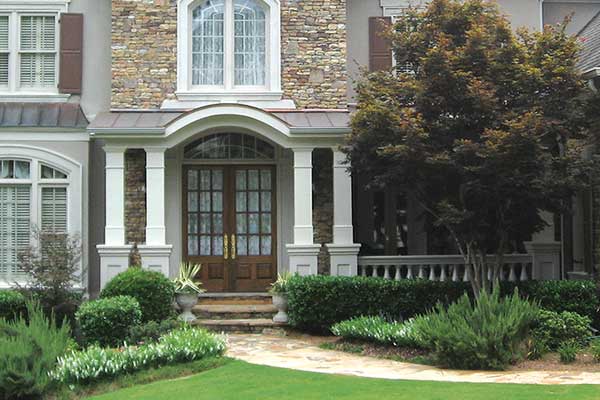 AFTER front porch with thick square white columns and double wooden door up close 2