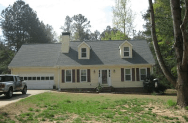 BEFORE installation of stone front porch of beige shingled home