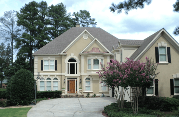 BEFORE installation of portico on large beige home