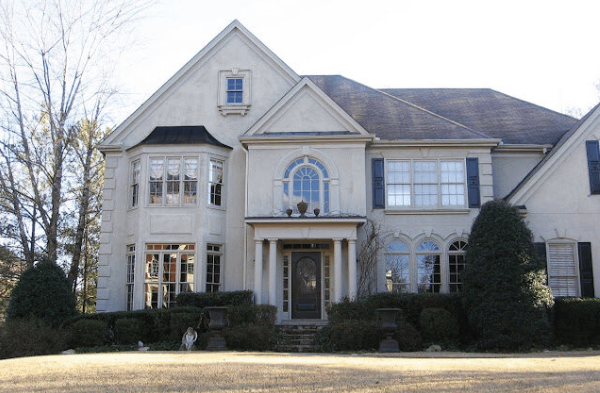 AFTER portico installation with double white columns on large white home