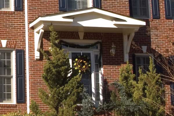 AFTER installation of bracket portico with glass door on brick home