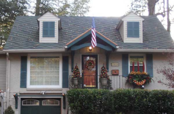 AFTER installation of bracket portico with grey home blue/grey shutters