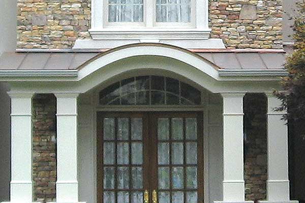 Brown steel roof over front porch