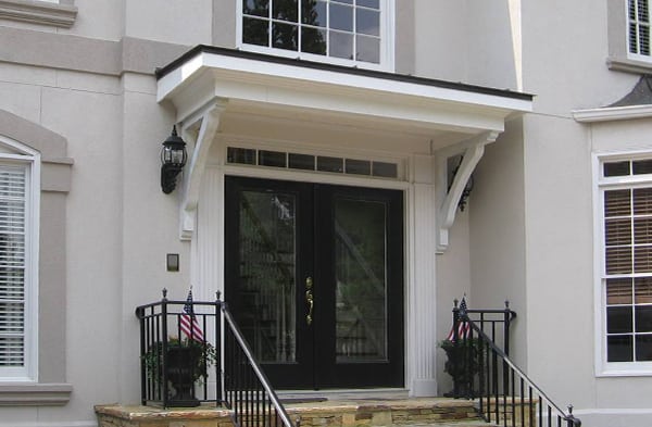 portico on grey house with black double doors black railing and stone steps