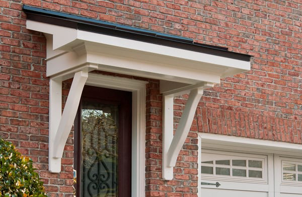 AFTER side back door portico on brick home with white garage door