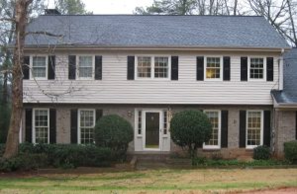 BEFORE installation of hip roof portico on white shingled and brick house with black shutters