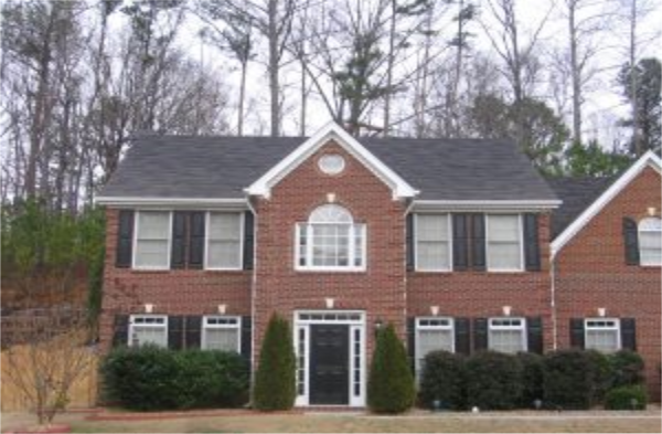 BEFORE installation of a gable roof portico with square columns on large brick house