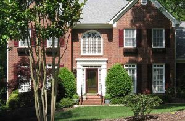 BEFORE installation of hip roof portico on brick house with burgundy shutters