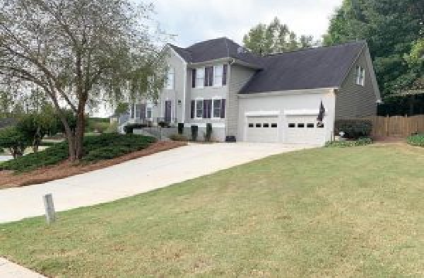 BEFORE gabled roof portico installation on grey home with black shutters and white trim