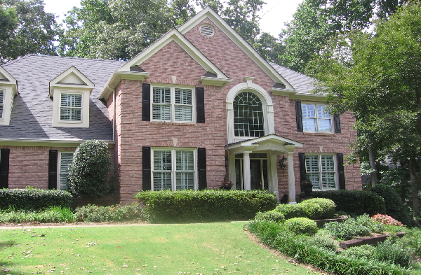 AFTER installation of a gable roof portico on large brick house