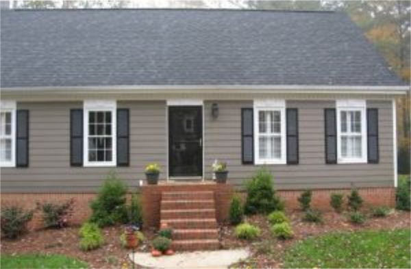 BEFORE installation of gabled roof portico on grey shingled home with black shutters