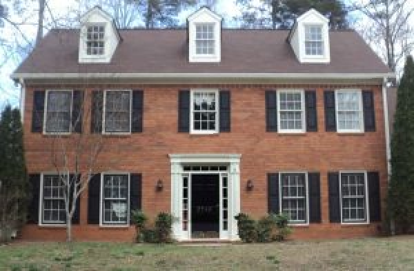 BEFORE installation of gabled roof portico on brick home with 9 windows