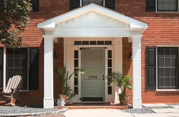 AFTER installation of gabled roof portico on brick home with adirondack chair