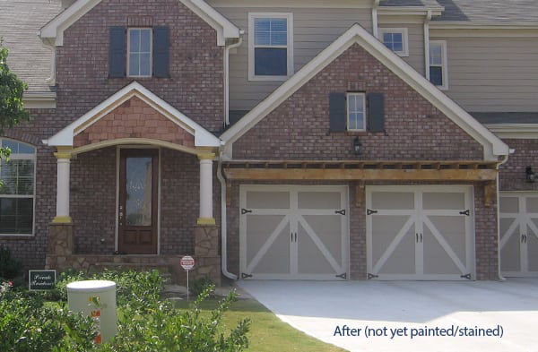 AFTER installation of gabled roof portico with wood shingles on brick home with two car garage