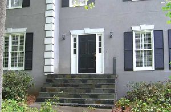 BEFORE installation of gabled roof portico on grey home with black shutters and stone steps 2