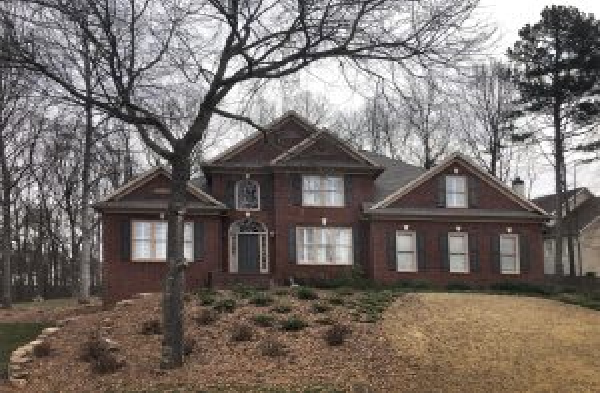 BEFORE installation of gabled roof portico with wooden columns on brick home before painted white