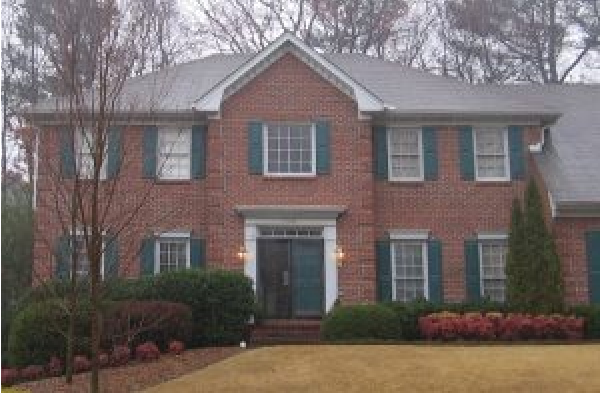 BEFORE installation of hip roof portico on brick house with green shutters