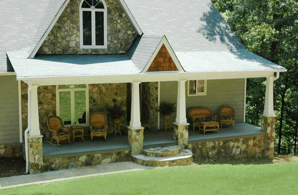 stone front porch with white columns and stone bases