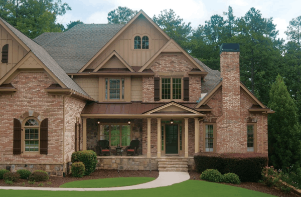 AFTER installation of portico on large multi-colored brick home