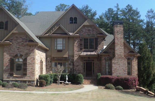 BEFORE installation of portico on large multi-colored brick home 2