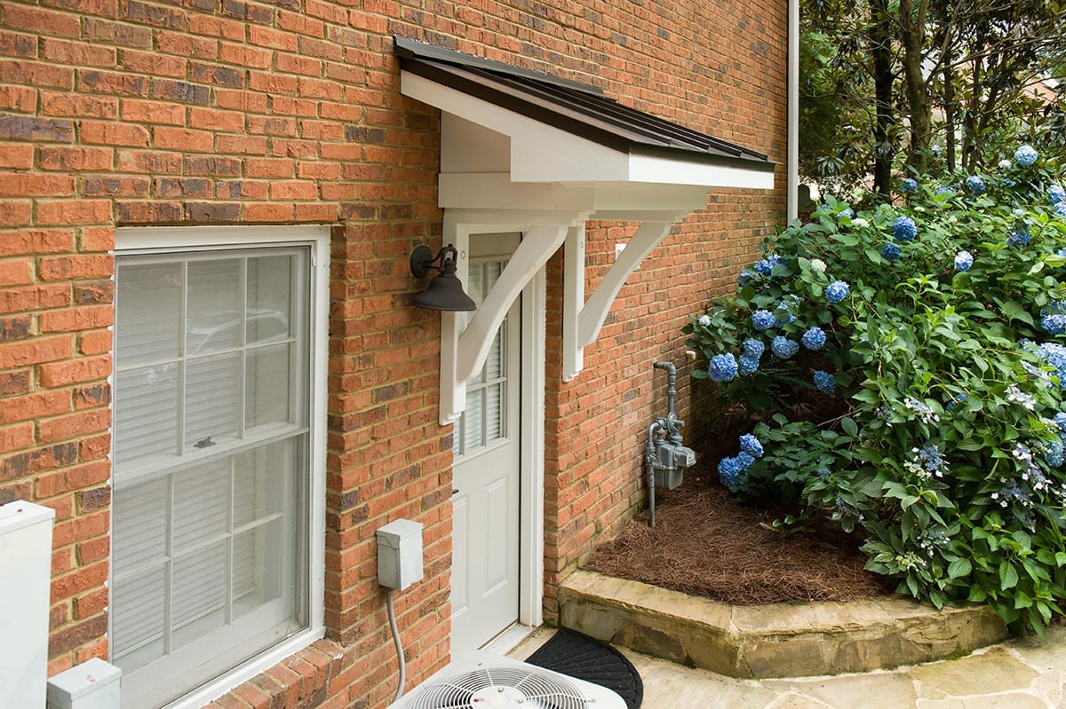 side door portico on brick house with hydrangeas 2