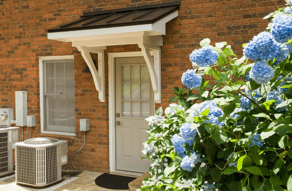 AFTER side back door portico on brick home with white door hydrangea