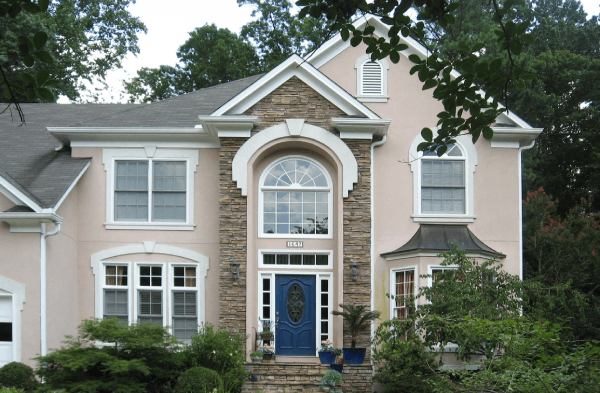 BEFORE installation of stone front porch on beige house with white trim and blue door