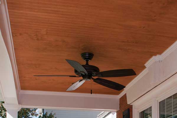 Tongue and groove front porch wood ceiling with fan