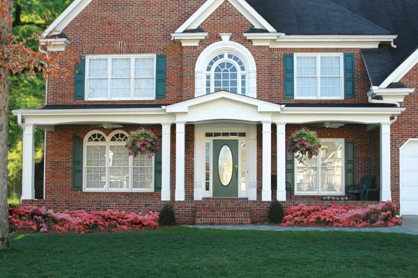 BEFORE installation of traditional front porch with double white columns in front of door