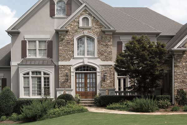 BEFORE installation of traditional front porch on grey and stone house 2