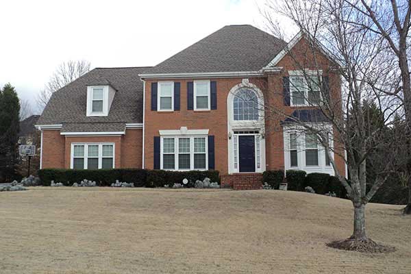 BEFORE installation of traditional front half porch on brick house with black shutters wintertime