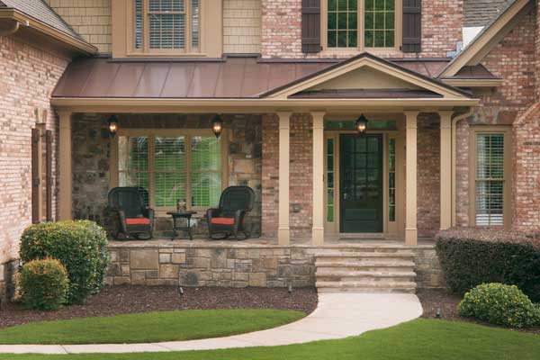 AFTER installation of portico on large multi-colored brick home up close 2