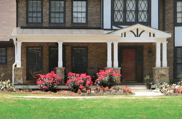 AFTER installation of gabled roof portico on tudor brick home close up