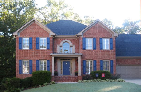 shed roof portico on brick home with blue shutters AFTER photo