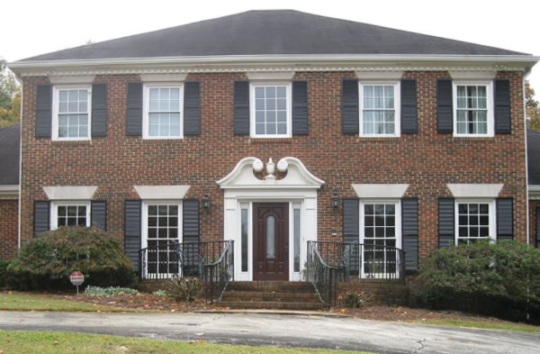 brick home black shutters BEFORE shed roof portico installation