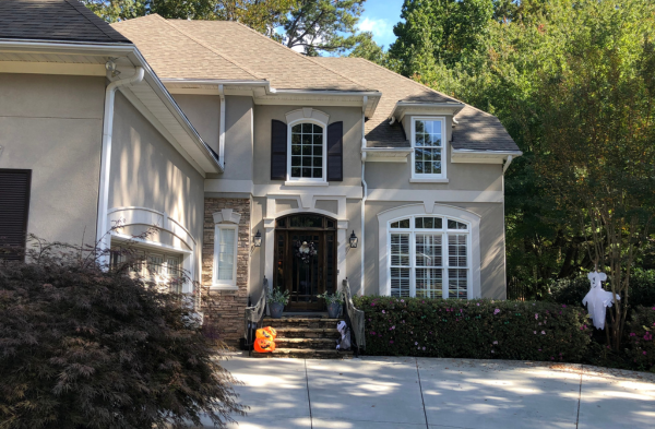 BEFORE installation of arched roof portico with beige home and brown door