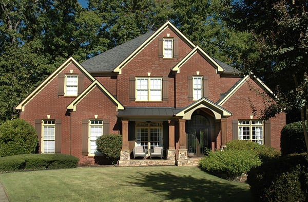 AFTER installation of stone front porch on large brick home front yard view