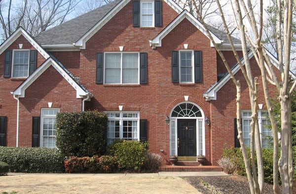 BEFORE installation of stone front porch on large brick home with round top door