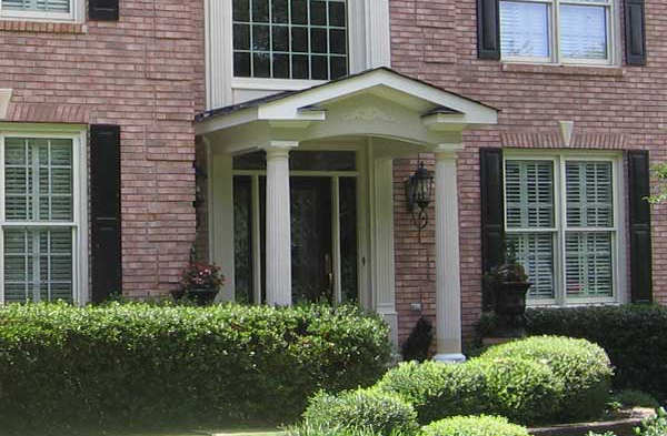 AFTER installation of gabled roof portico on brick home with white columns