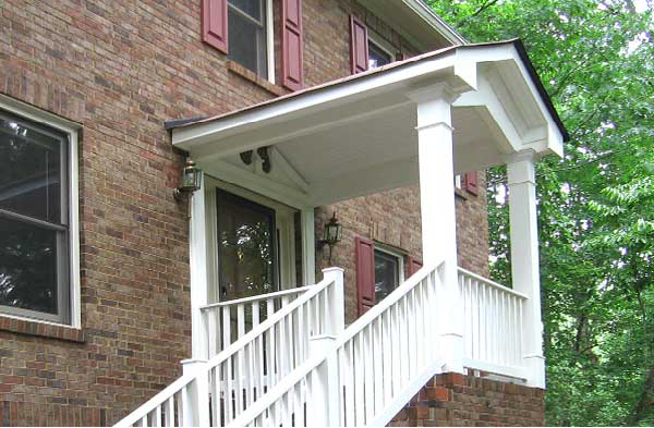 AFTER installation of gabled roof portico on brick home with white railing