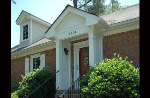 AFTER installation of white gabled roof portico on brick home with brick steps