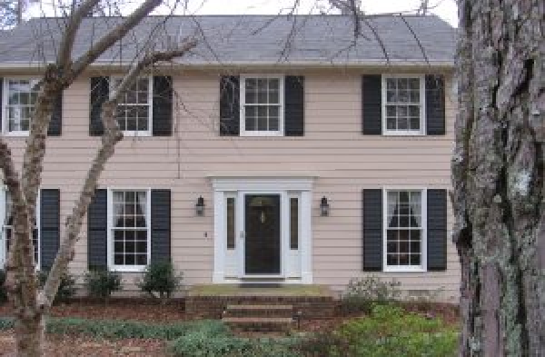 BEFORE installation of gabled roof portico on beige shingled home