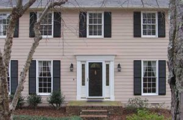 close up BEFORE installation of gabled roof portico on beige shingled home