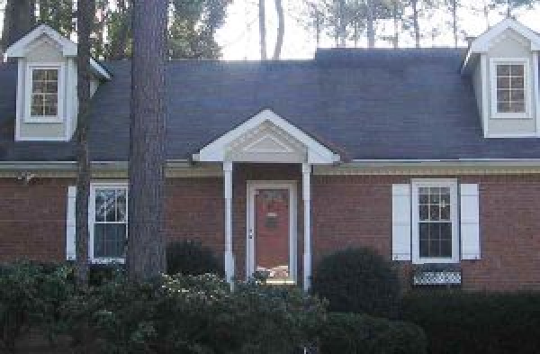 BEFORE installation of white gabled roof portico on brick home with brick steps