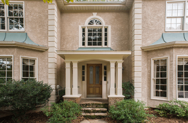 AFTER installation of hip roof portico on tan stucco house 2