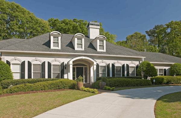 AFTER installation of arched roof portico on white house with black shutters 2